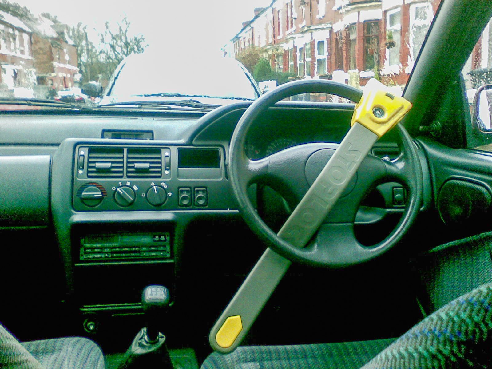 Photograph of a steering wheel lock clamped across the steering wheel of a UK right-hand-drive car