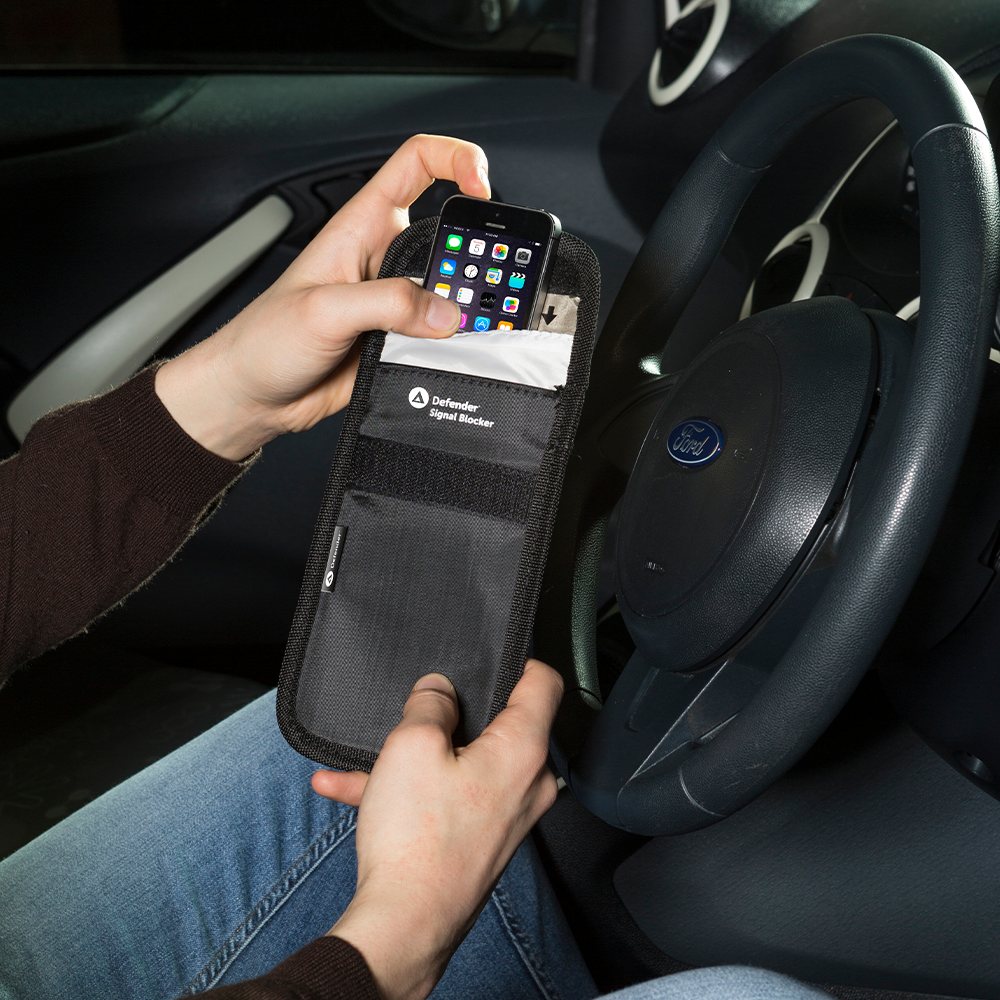 A Defender Faraday pouch holding a car key fob