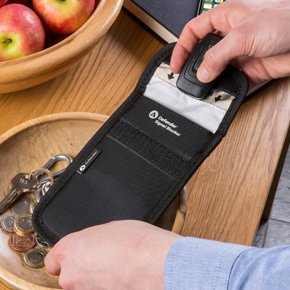 A Defender Faraday pouch with the fold-over flap open, showing the lined interior